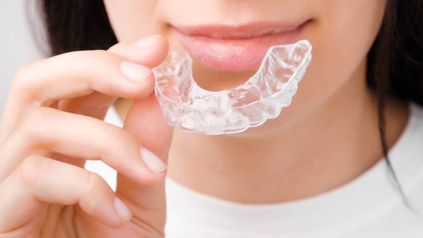 mujer sonriendo mientas sostiene una funda invisible